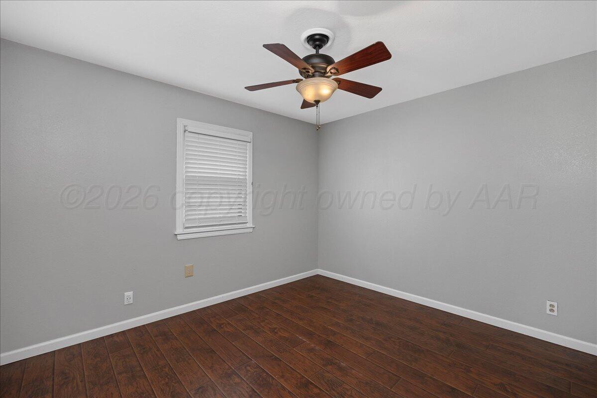 1415 Southwest 34th Avenue Amarillo, TX 79109 - Photo 15 of 22 a view of a room with wooden floor and a ceiling fan