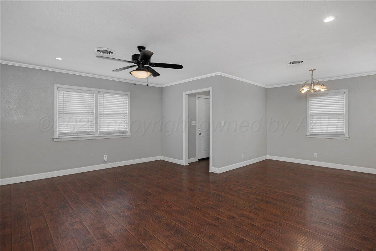 1415 Southwest 34th Avenue Amarillo, TX 79109 - Photo 3 of 22 a view of an empty room with window and wooden floor