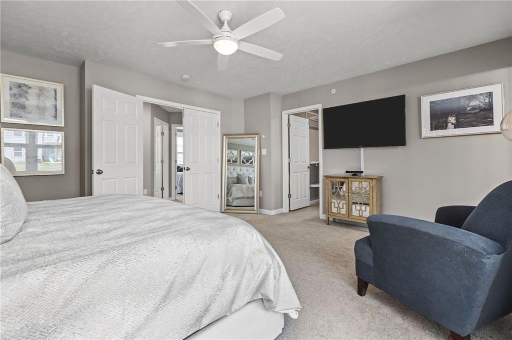 217 Lockheed Drive Coraopolis, PA 15108 - Photo 16 of 27 a spacious bedroom with a bed a couch and a flat screen tv