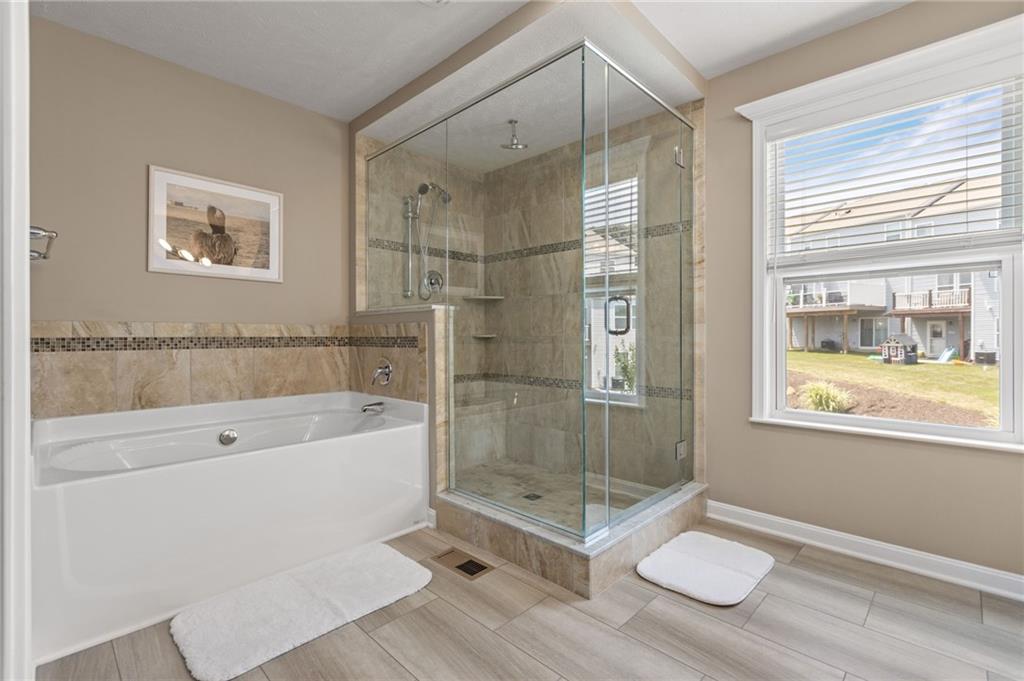 217 Lockheed Drive Coraopolis, PA 15108 - Photo 17 of 27 a bathroom with a granite countertop bathtub shower sink vanity and toilet