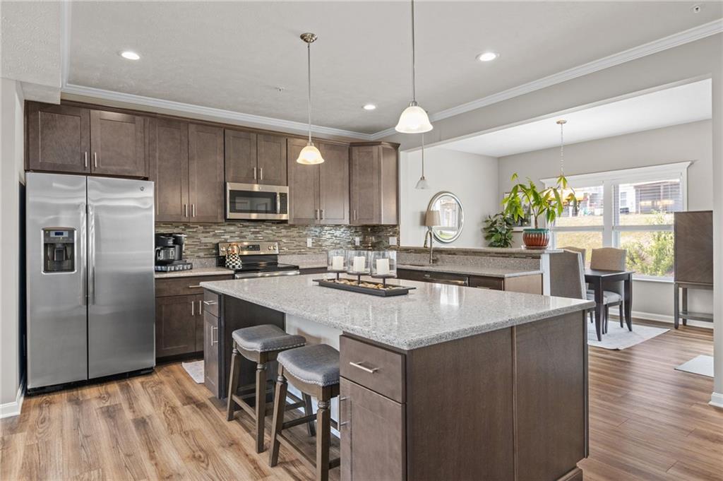 217 Lockheed Drive Coraopolis, PA 15108 - Photo 2 of 27 a kitchen with granite countertop a sink a center island stainless steel appliances and cabinets