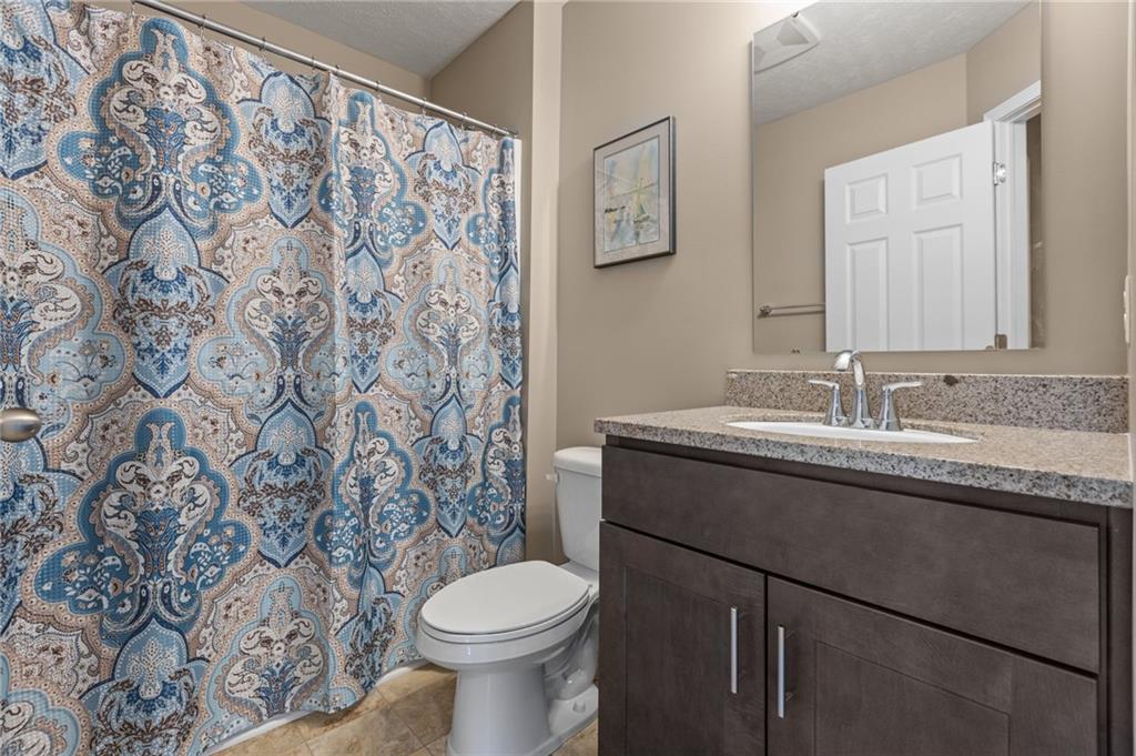 217 Lockheed Drive Coraopolis, PA 15108 - Photo 24 of 27 a bathroom with a granite countertop sink and a toilet