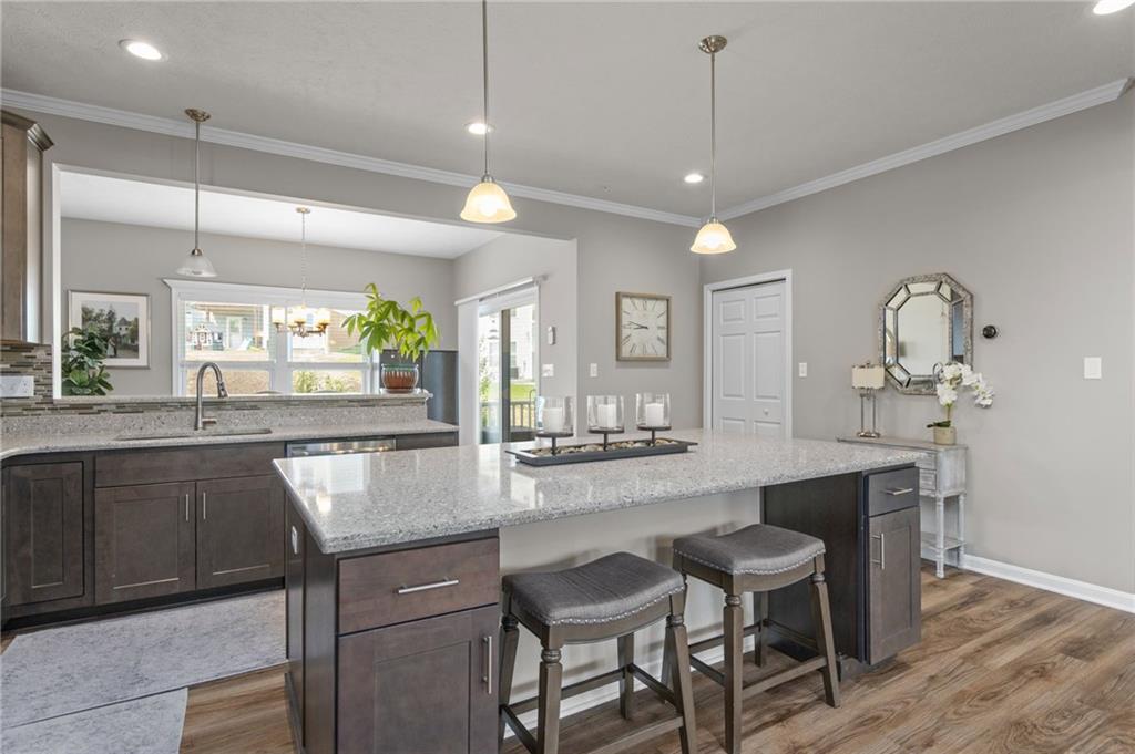 217 Lockheed Drive Coraopolis, PA 15108 - Photo 5 of 27 a kitchen with kitchen island granite countertop a table and chairs in it