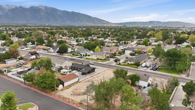 388 Wasatch Street Midvale, UT 84047 - Photo 5 of 13 Expansive cleared lot bordered by perimeter fencing, offering direct road access