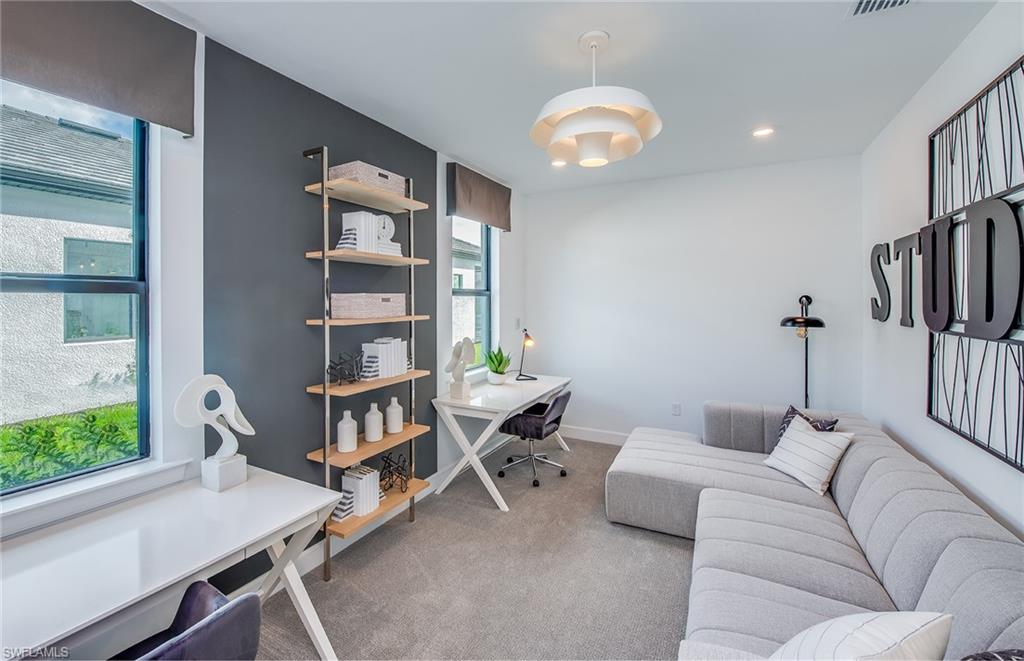 19061 Gentry Place Estero, FL 33928 - Photo 15 of 49 a living room with furniture and a book shelf
