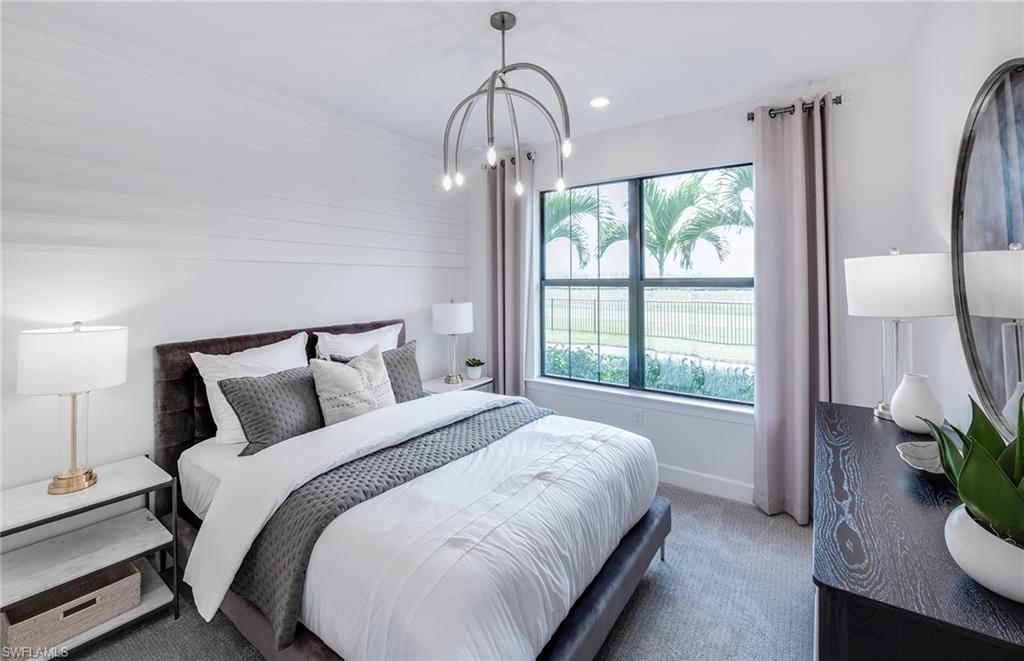 19061 Gentry Place Estero, FL 33928 - Photo 18 of 49 a bedroom with a bed lamps and table