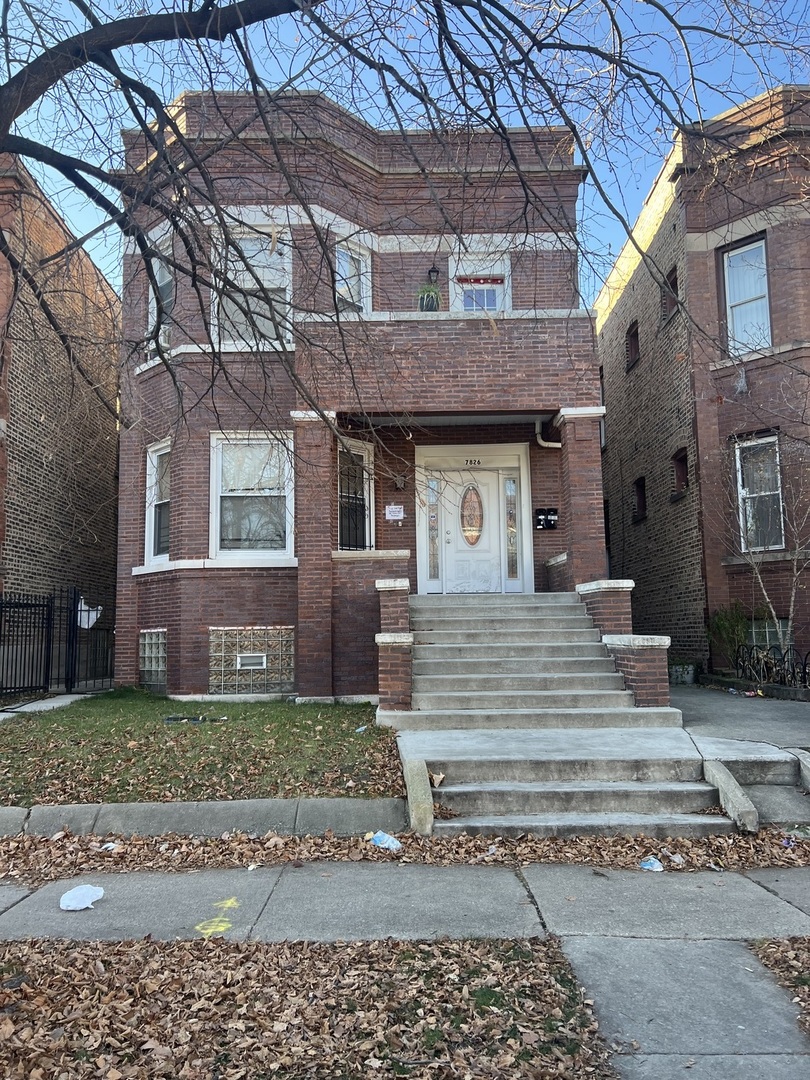 7826 South Morgan Street Chicago, IL 60620 - Photo 2 of 16 a front view of a house with a yard