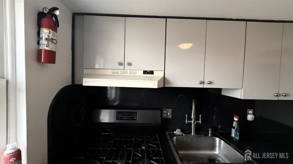 a kitchen with a sink and cabinets