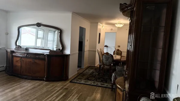 a room with wooden floor and furniture