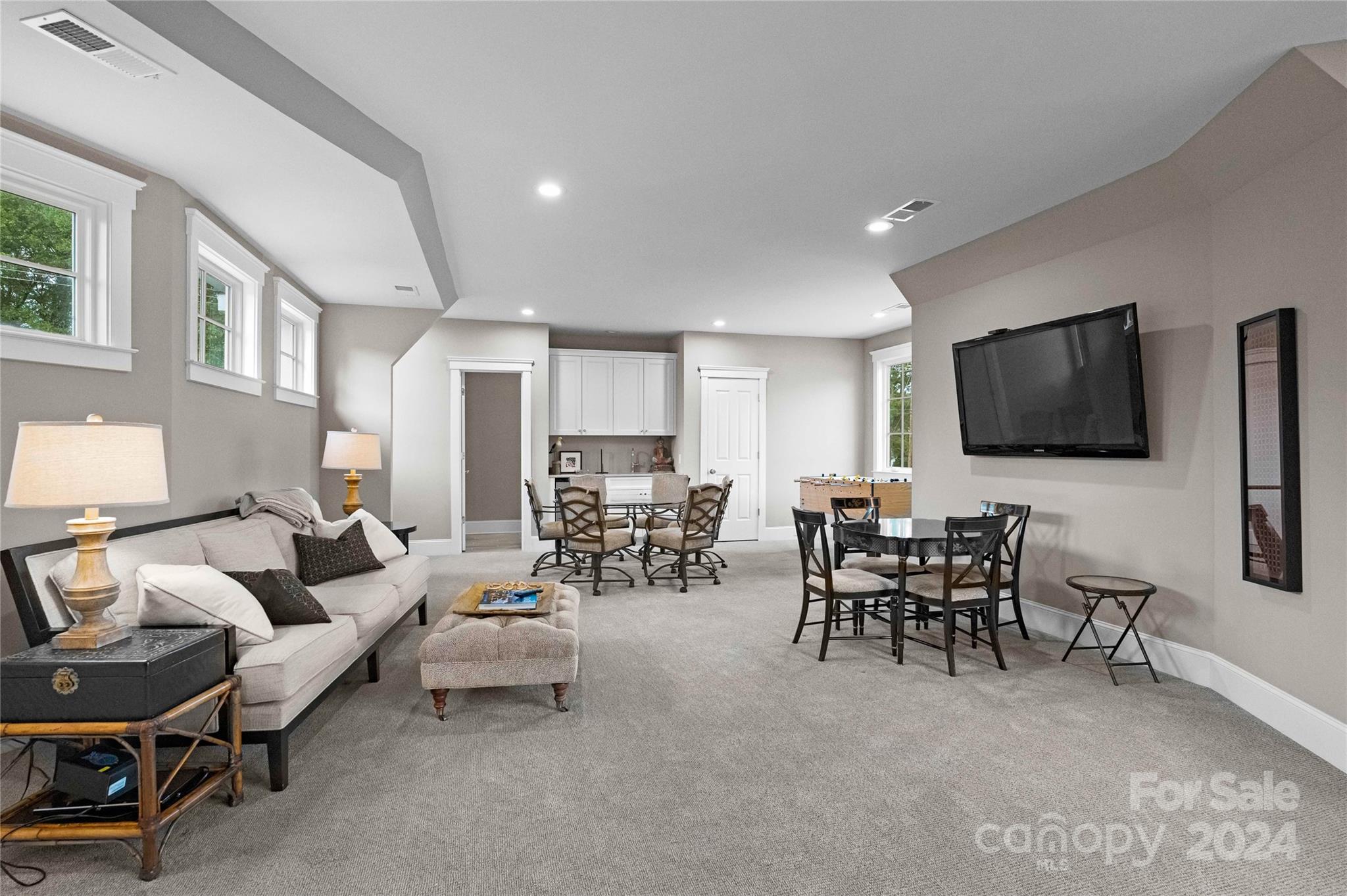 18121 John Connor Road Cornelius, NC 28031 - Photo 24 of 43 a living room with furniture and a flat screen tv
