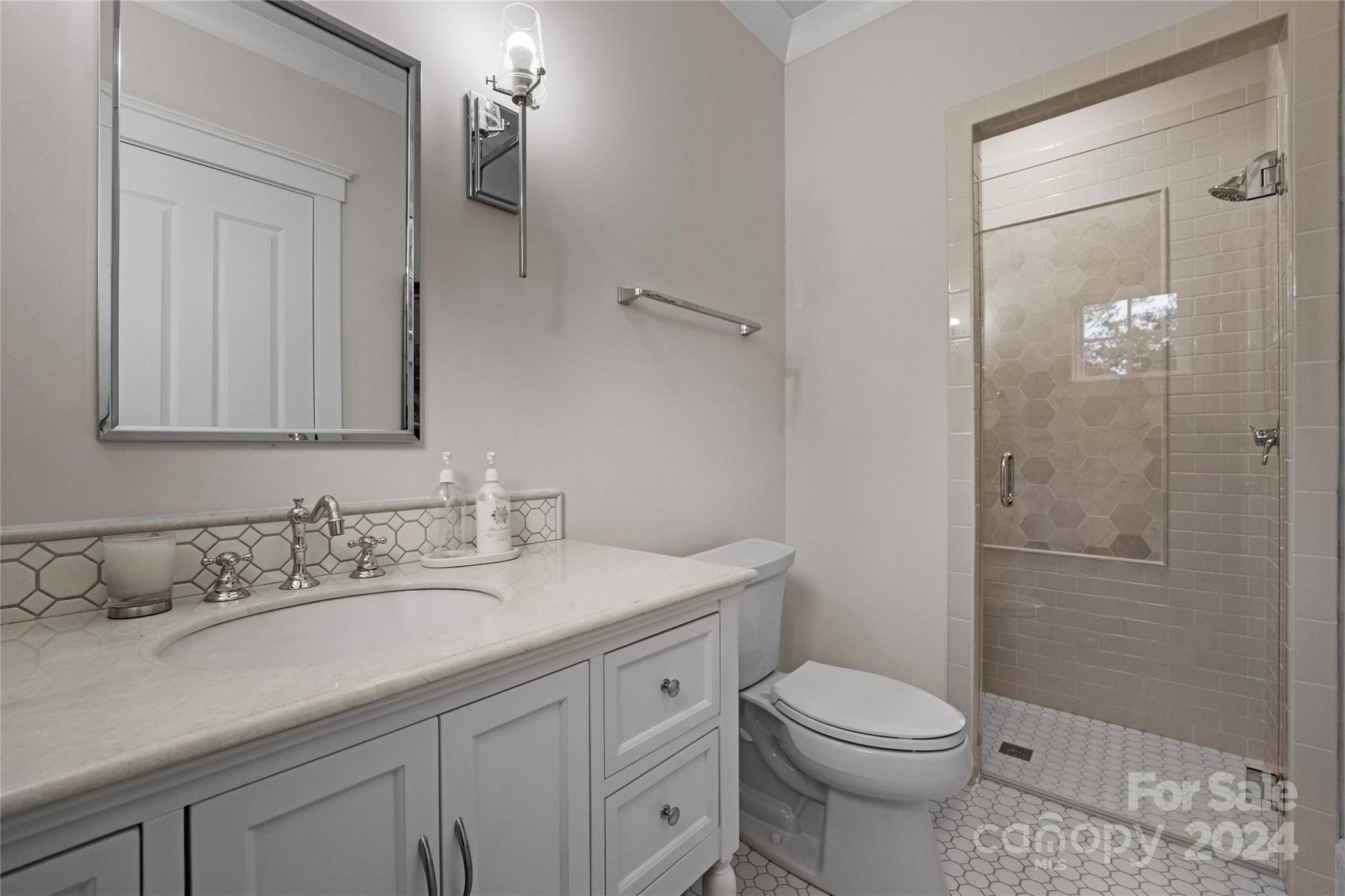 18121 John Connor Road Cornelius, NC 28031 - Photo 30 of 43 a bathroom with a sink a toilet and shower