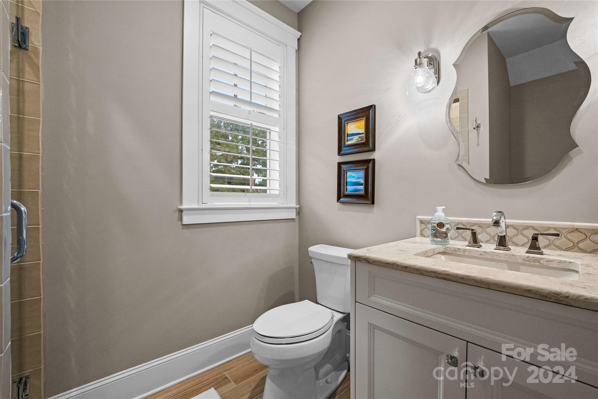 18121 John Connor Road Cornelius, NC 28031 - Photo 35 of 43 a bathroom with a toilet sink and mirror
