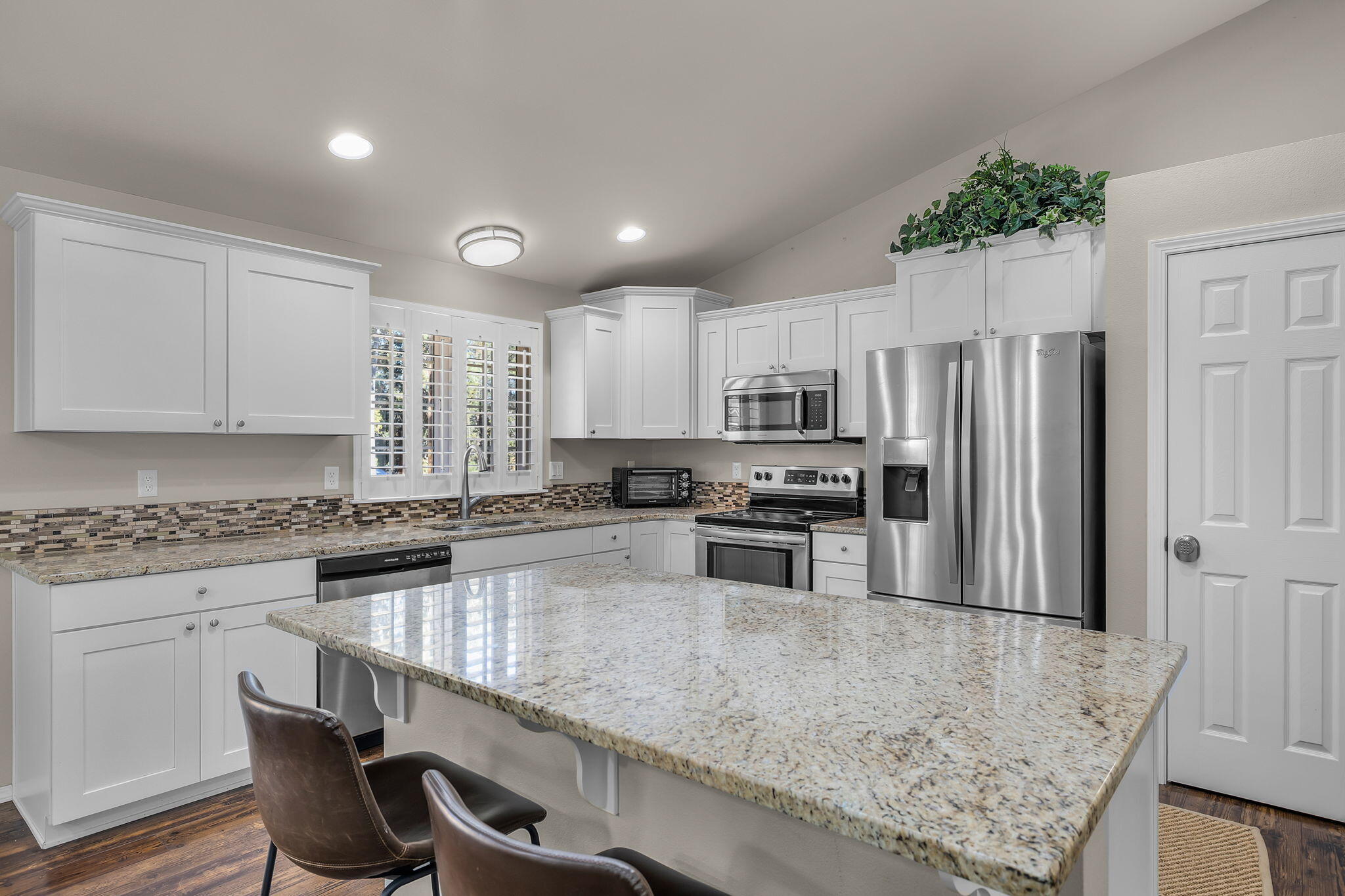 17064 Sacramento Road Bend, OR 97707 - Photo 11 of 50 a kitchen with stainless steel appliances granite countertop a sink refrigerator and microwave