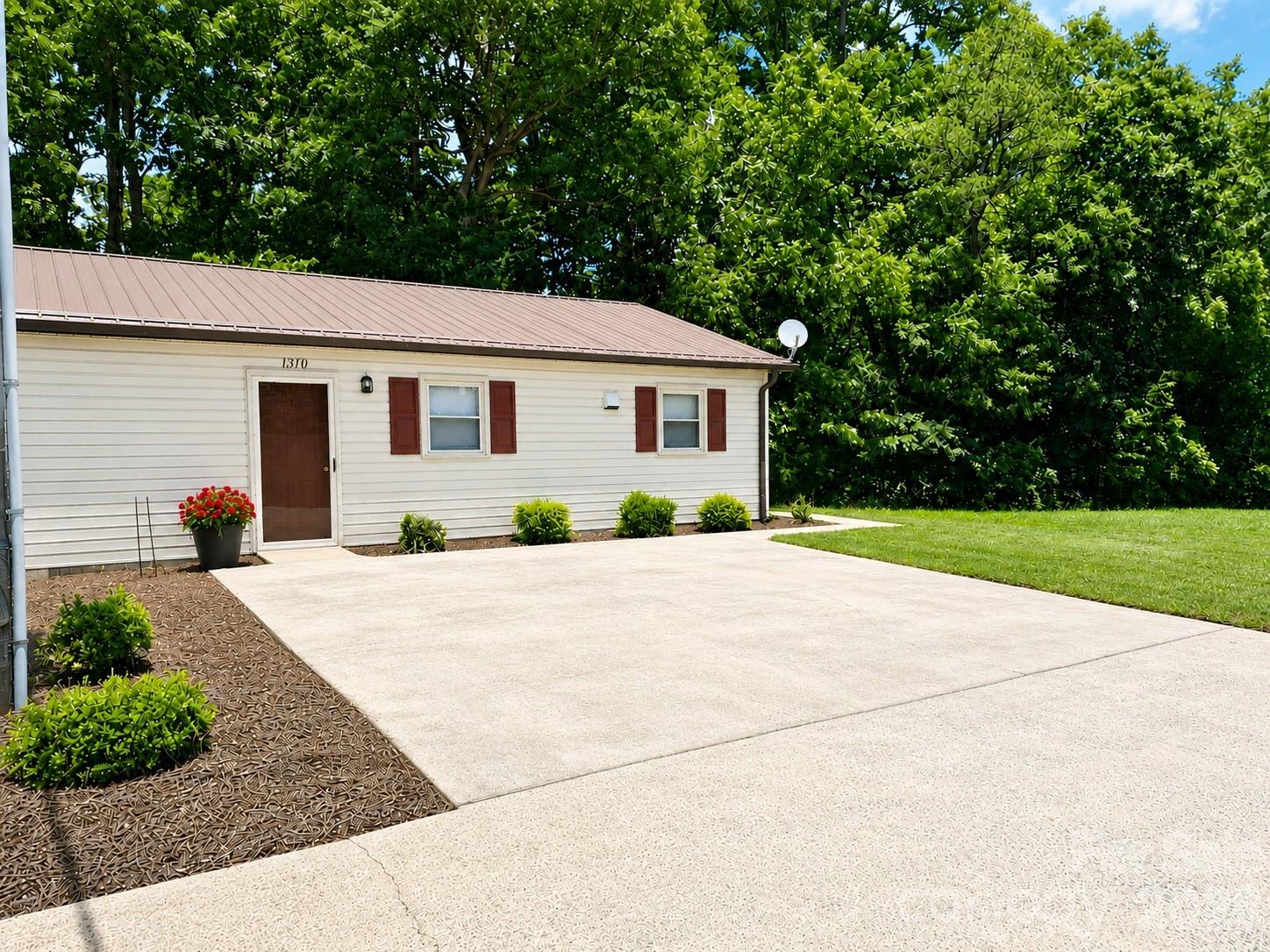 1368 Cajah Mountain Road Hudson, NC 28638 - Photo 36 of 46 a front view of a house with yard and a garage