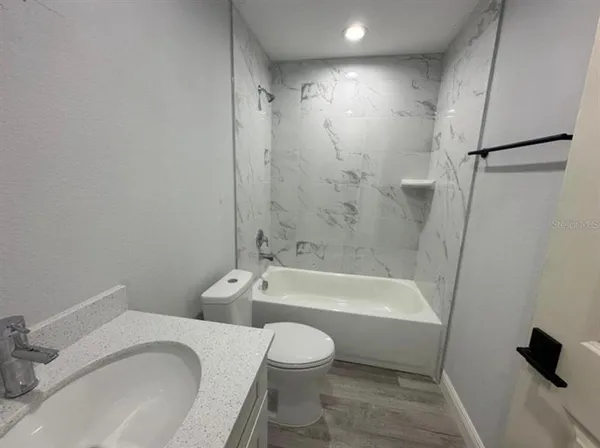 a bathroom with a toilet and a bath tub