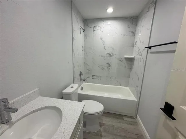 a bathroom with a toilet and a bath tub