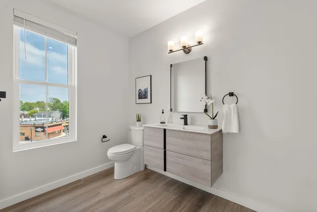 a bathroom with a sink toilet and a mirror