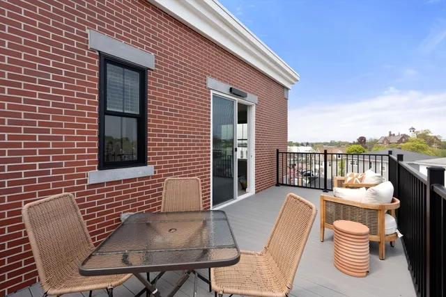 a view of a chair and tables in the balcony