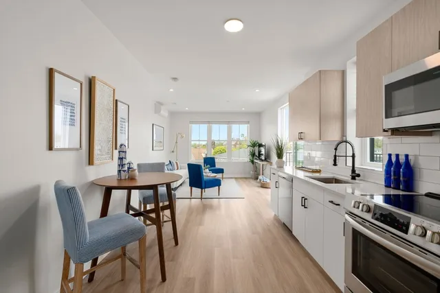 a large kitchen with a table and chairs