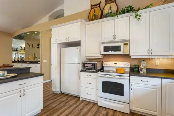 a kitchen with cabinets a sink and appliances
