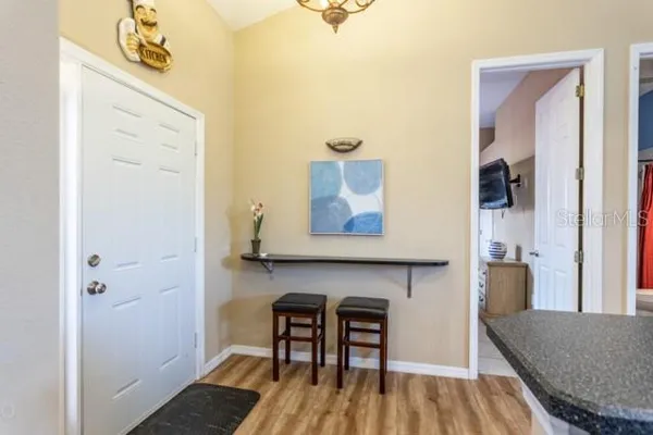 a kitchen with a sink and dishwasher with white cabinets