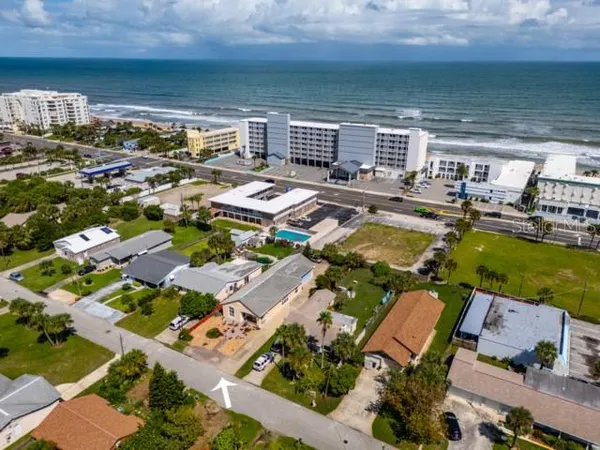 an aerial view of a house with swimming pool and outdoor seating