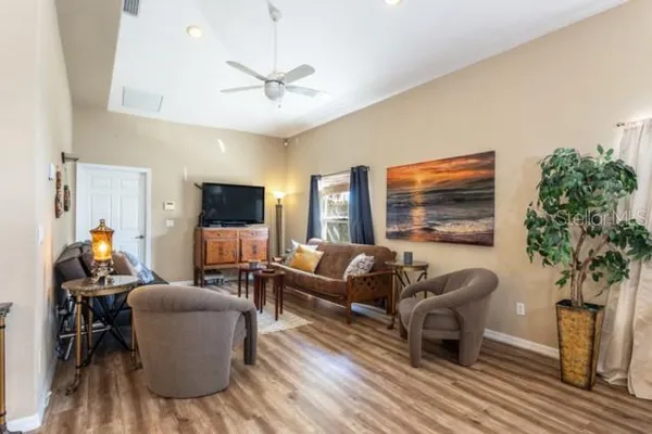 a living room with furniture and a flat screen tv