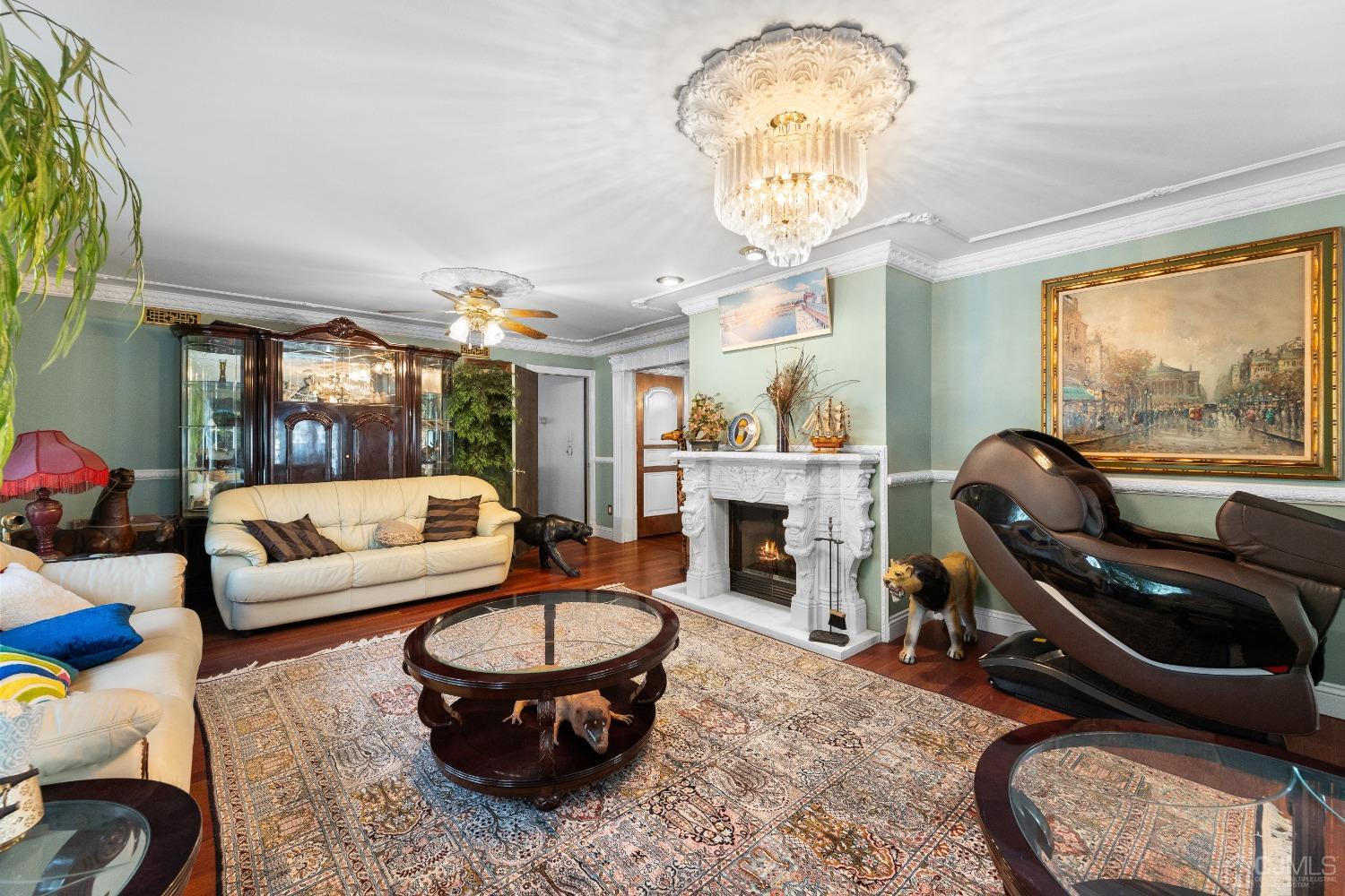 16 Parson Place Colonia, NJ 07067 - Photo 18 of 70 a living room with furniture a chandelier and a fireplace