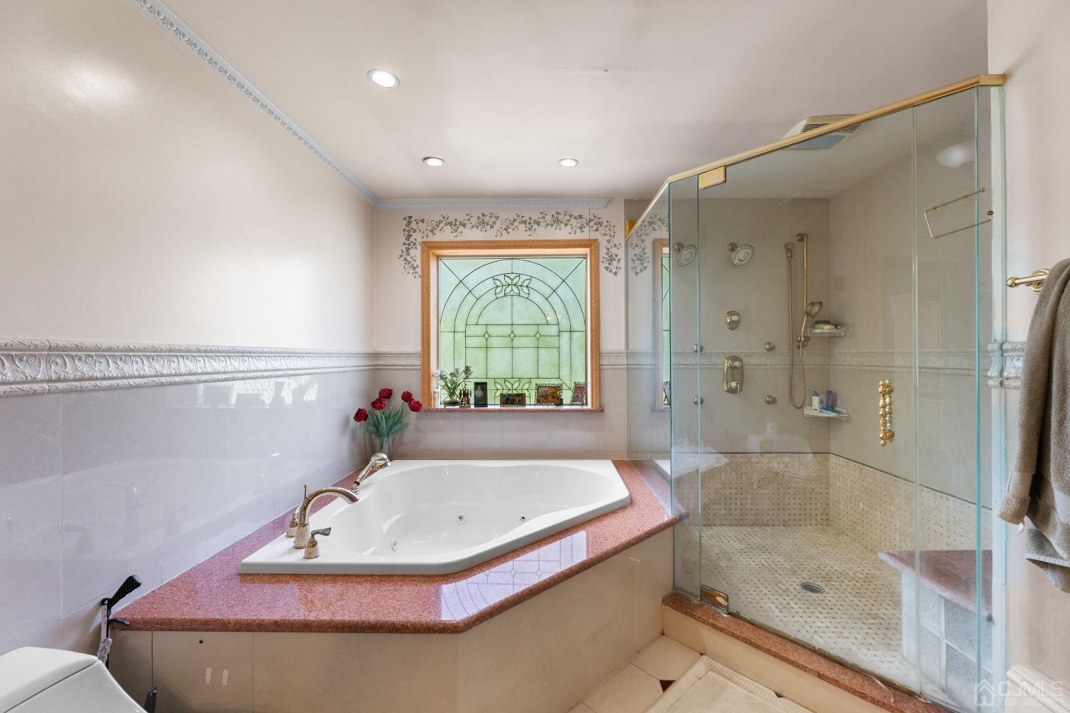 16 Parson Place Colonia, NJ 07067 - Photo 36 of 70 a bathroom with a tub and a shower