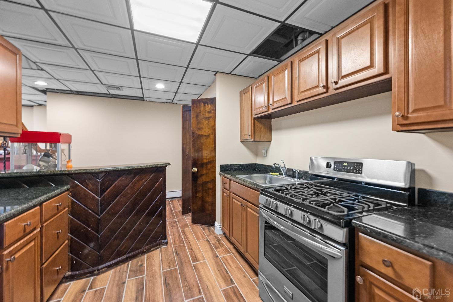 16 Parson Place Colonia, NJ 07067 - Photo 52 of 70 a kitchen with stainless steel appliances granite countertop a stove and a microwave
