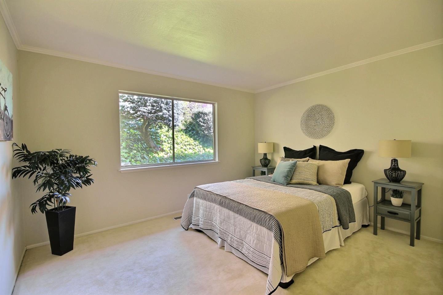 1817 Hunt Drive Burlingame, CA 94010 - Photo 14 of 20 a bedroom with a bed and a potted plant