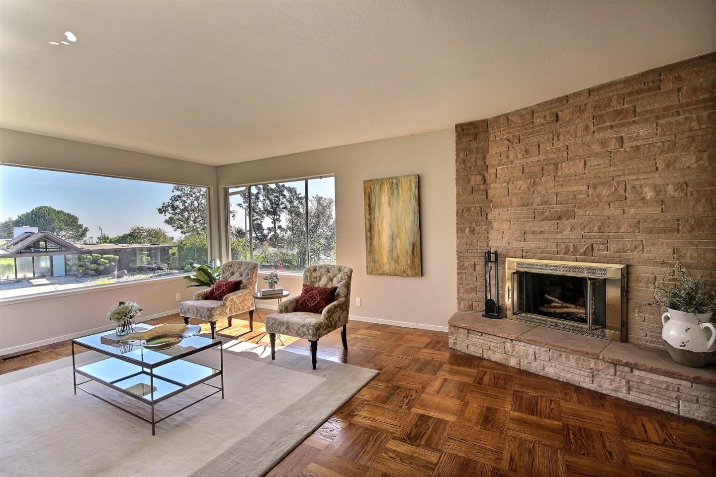 1817 Hunt Drive Burlingame, CA 94010 - Photo 5 of 20 a living room with furniture a fireplace and a floor to ceiling window