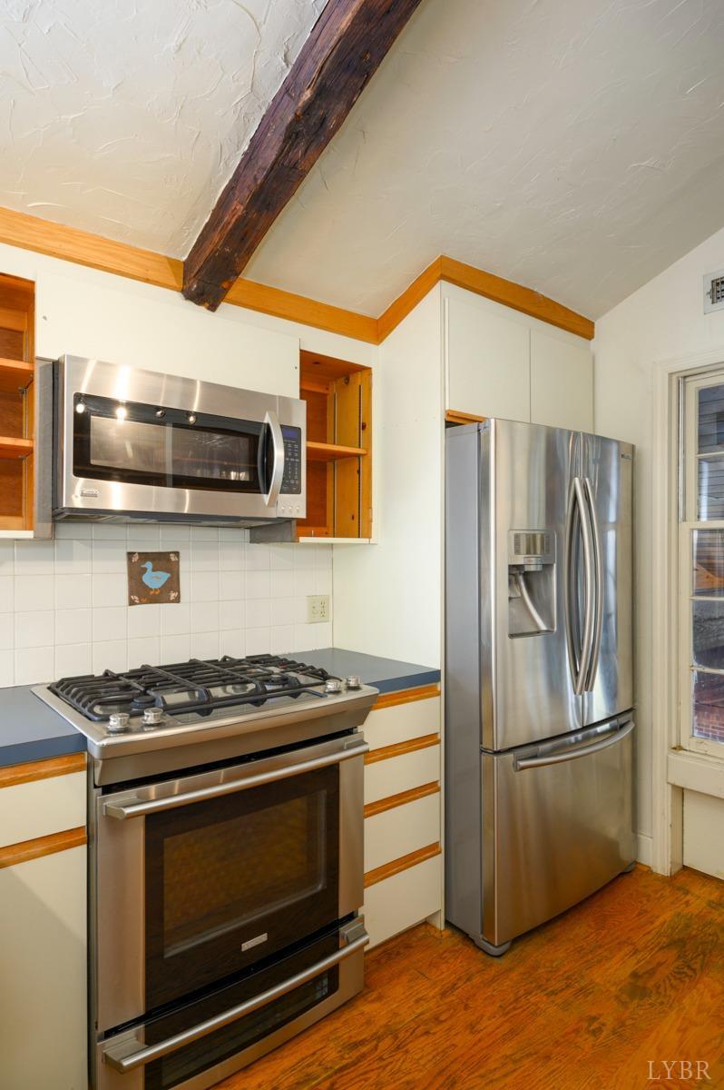 2812 Link Road Lynchburg, VA 24503 - Photo 17 of 65 a kitchen with stainless steel appliances granite countertop a stove microwave and refrigerator