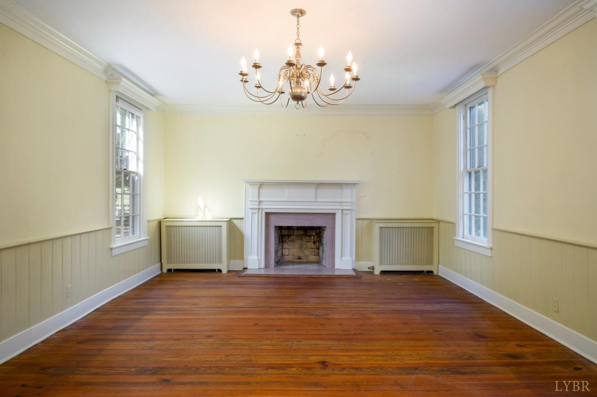 2812 Link Road Lynchburg, VA 24503 - Photo 10 of 65 a view of a livingroom with a fireplace a chandelier and wooden floor