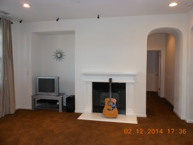 7542 Stoneleaf Road San Ramon, CA 94582 - Photo 23 of 24 a living room with furniture a fireplace and a flat screen tv