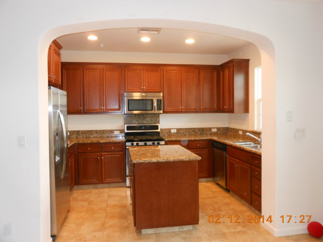 7542 Stoneleaf Road San Ramon, CA 94582 - Photo 3 of 24 a kitchen with stainless steel appliances granite countertop a stove refrigerator sink and microwave