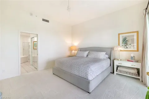 a bedroom with a bed and a lamp