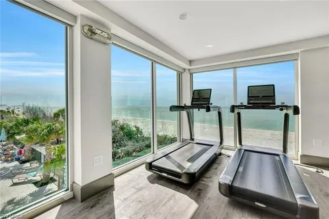 a room with gym equipment and a flat screen tv