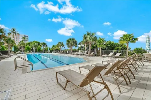 a view of swimming pool with outdoor seating and plants