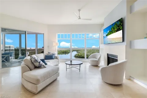 a living room with furniture kitchen view and a fireplace