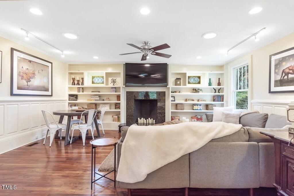 5612 Cabe Ford Road Durham, NC 27705 - Photo 11 of 42 a living room with furniture a fireplace and a flat screen tv