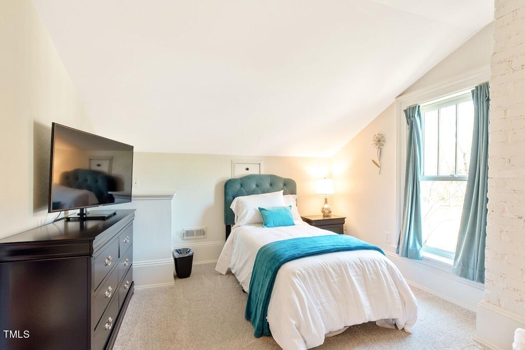 5612 Cabe Ford Road Durham, NC 27705 - Photo 27 of 42 a bedroom with a bed and flat screen tv