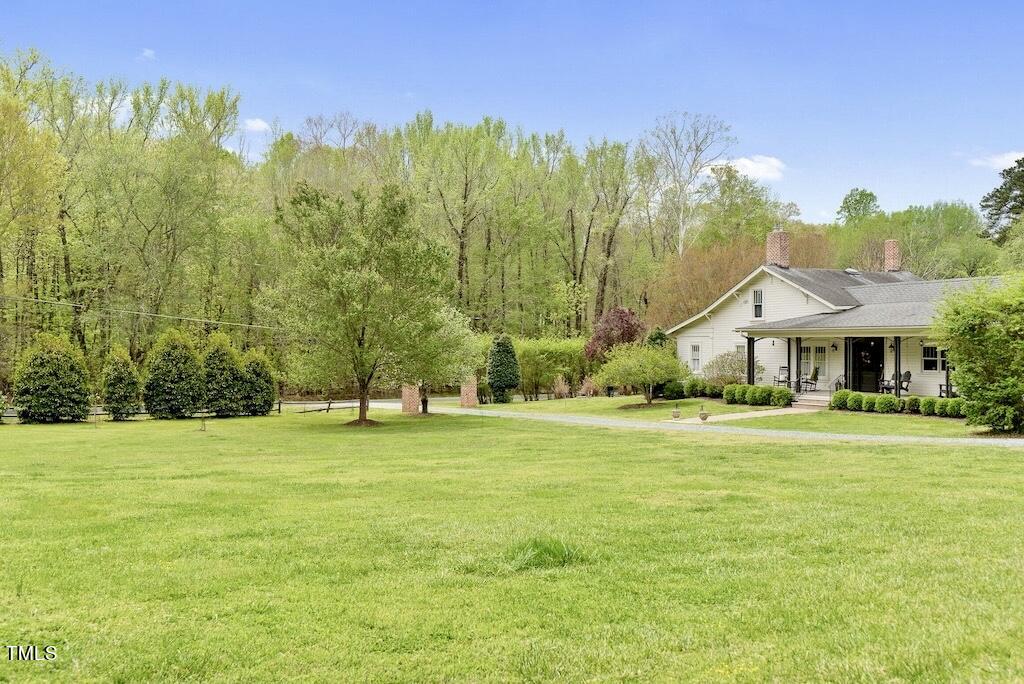 5612 Cabe Ford Road Durham, NC 27705 - Photo 3 of 42 a front view of a house with a yard and trees