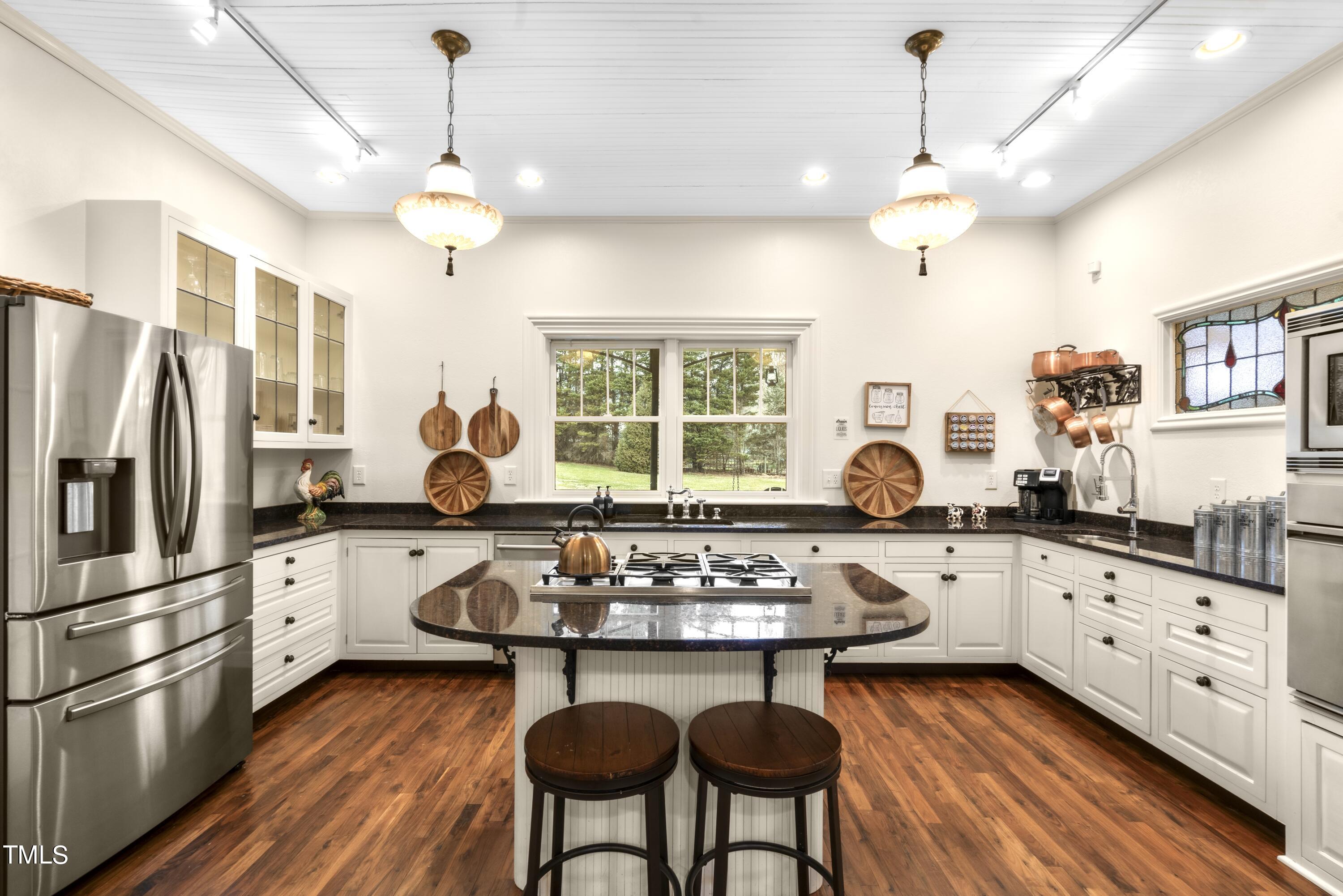 5612 Cabe Ford Road Durham, NC 27705 - Photo 9 of 42 a kitchen with stainless steel appliances granite countertop a stove and refrigerator