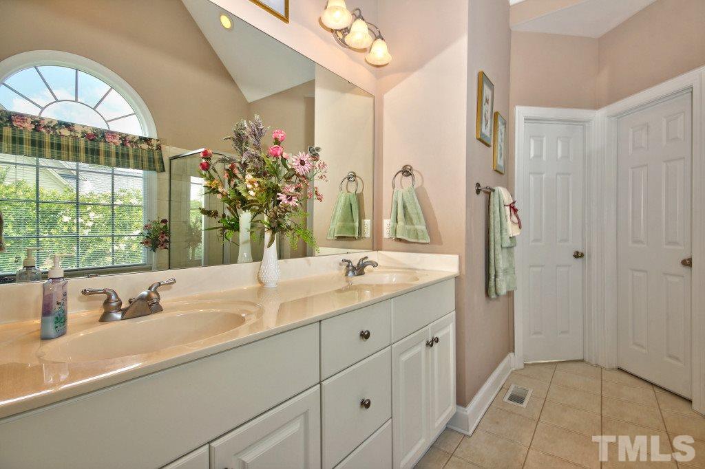1012 Pasture View Lane Raleigh, NC 27603 - Photo 14 of 25 a bathroom with a double vanity sink and a mirror