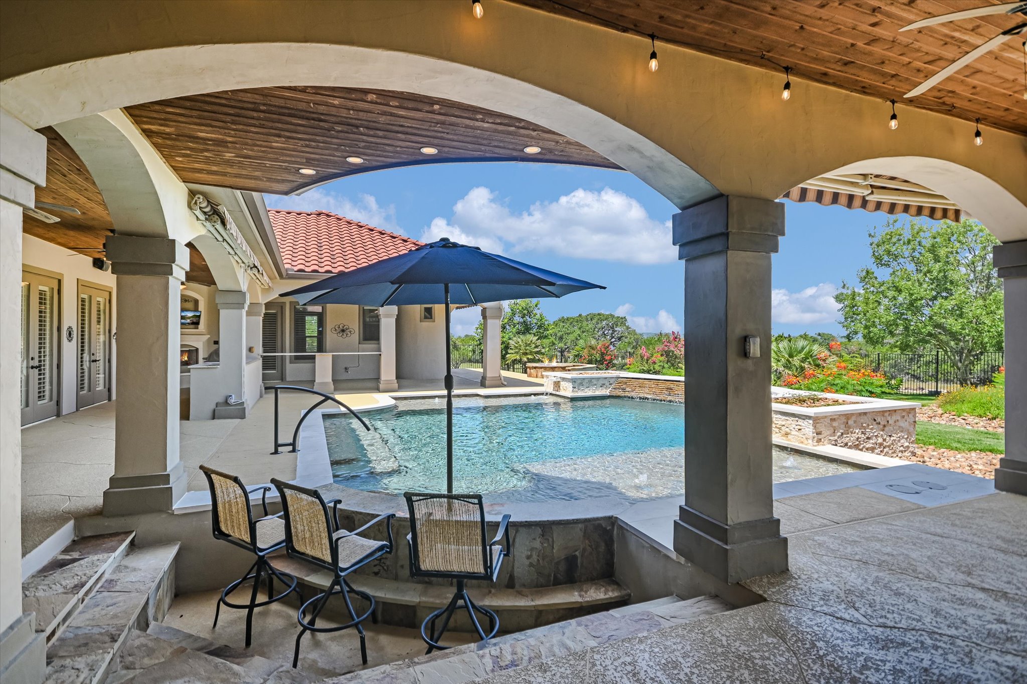 228 Puzzle Pass Spring Branch, TX 78070 - Photo 27 of 35 Elegant pool retreat features a swim-up bar, dual beach entries and stunning Hill Country views.
