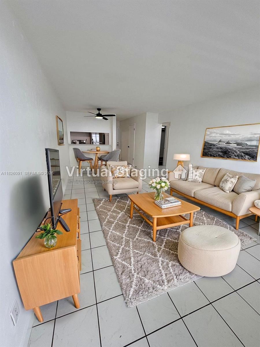 a living room with furniture a rug and a table