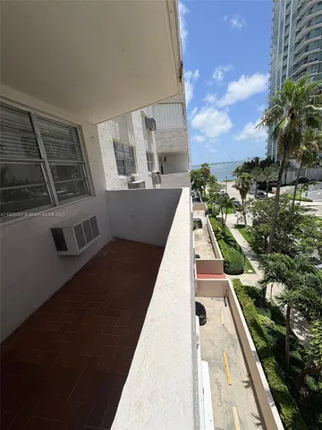 a view of a multi story building with yard