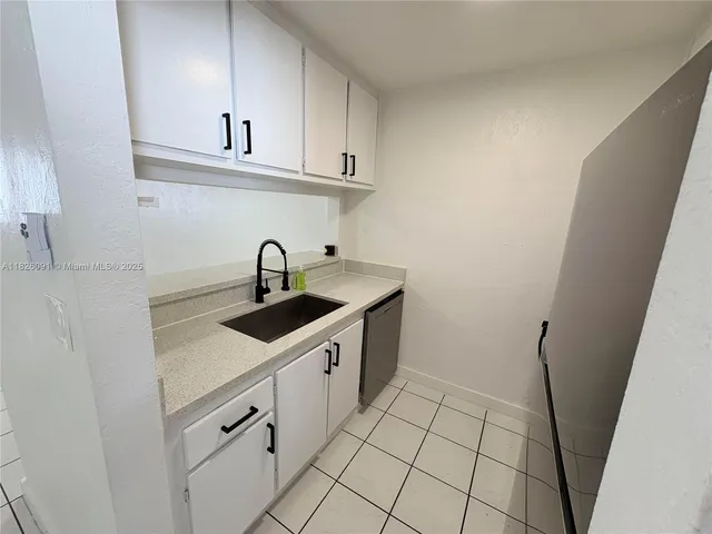 a kitchen with sink cabinets and window