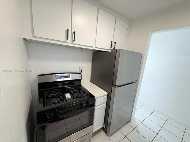 a stove top oven sitting inside of a kitchen